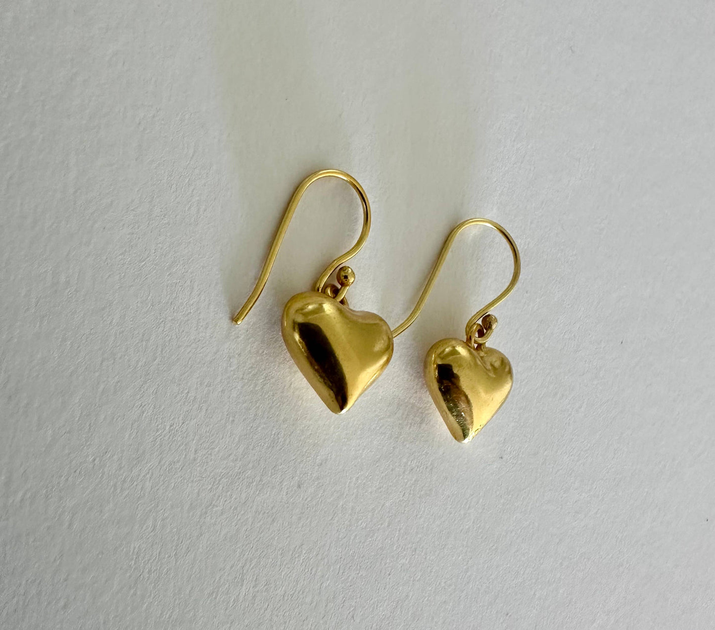 Small hearts gold dangle earrings by Anokhi Green, view 3