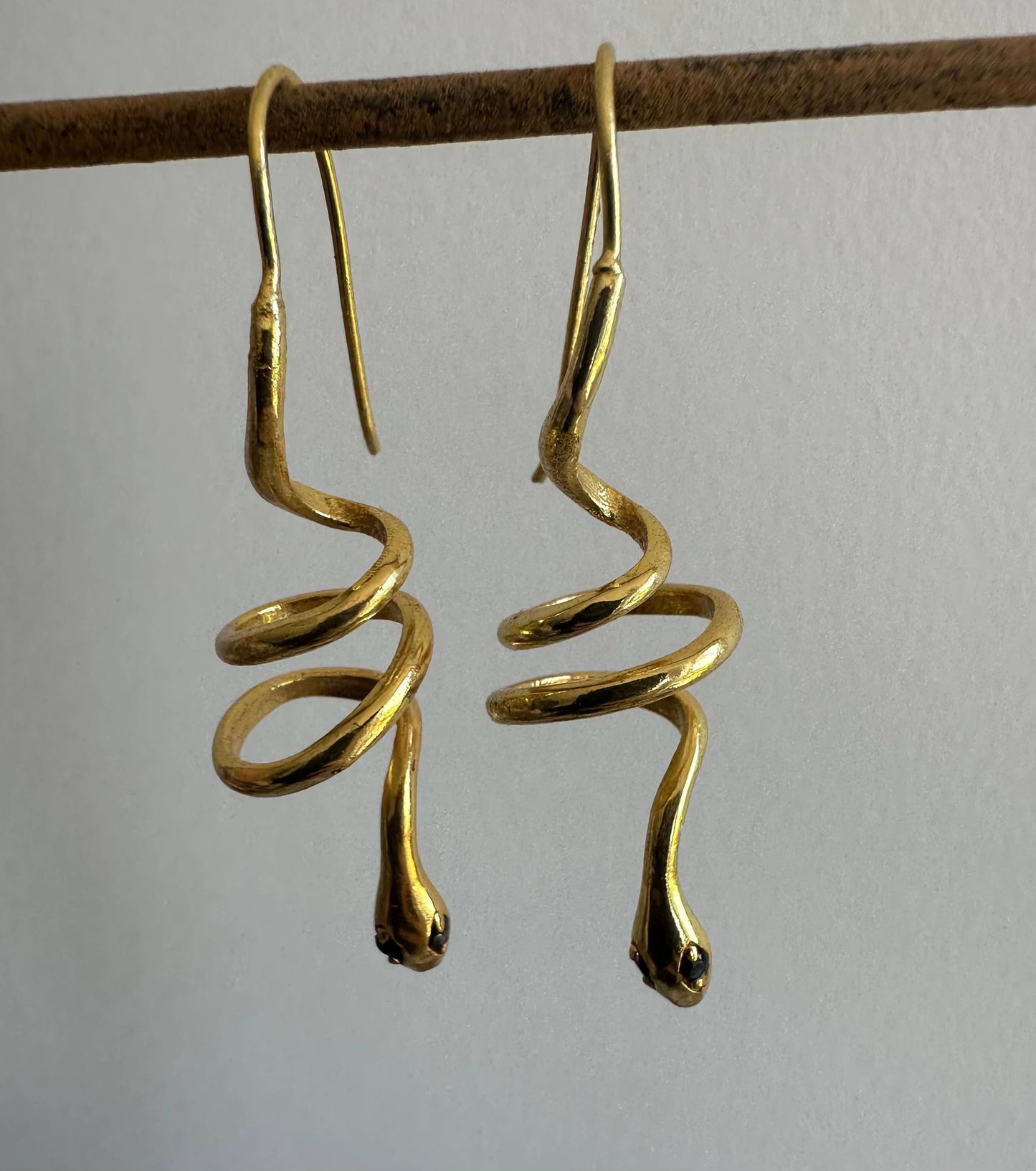 Gold snake earrings with green zircon eyes by Anokhi Green, view 5