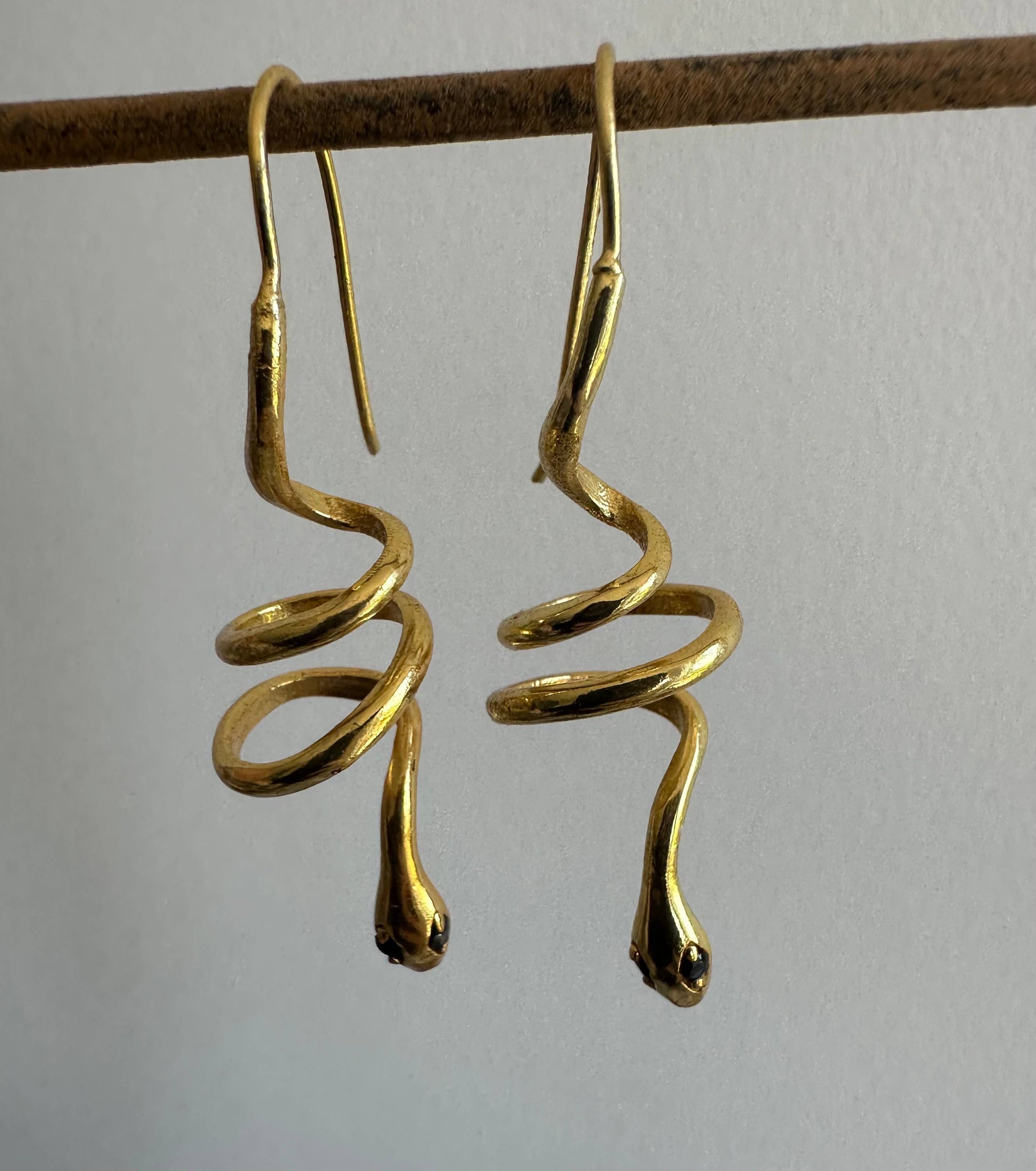 Gold snake earrings with green zircon eyes by Anokhi Green, view 5