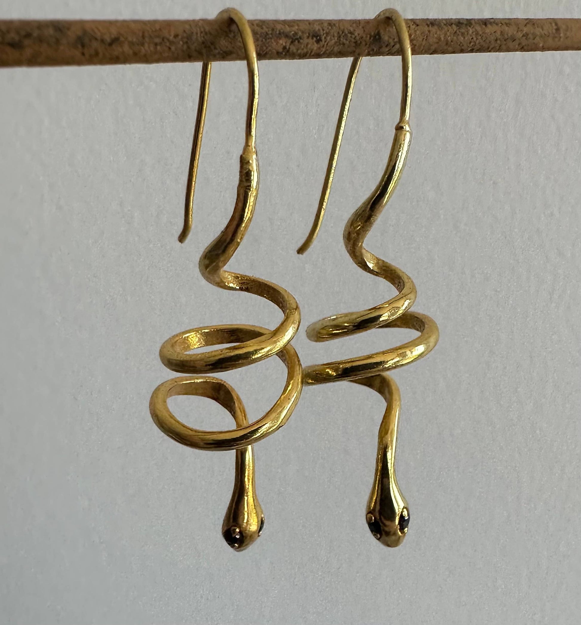 Gold snake earrings with green zircon eyes by Anokhi Green, view 6